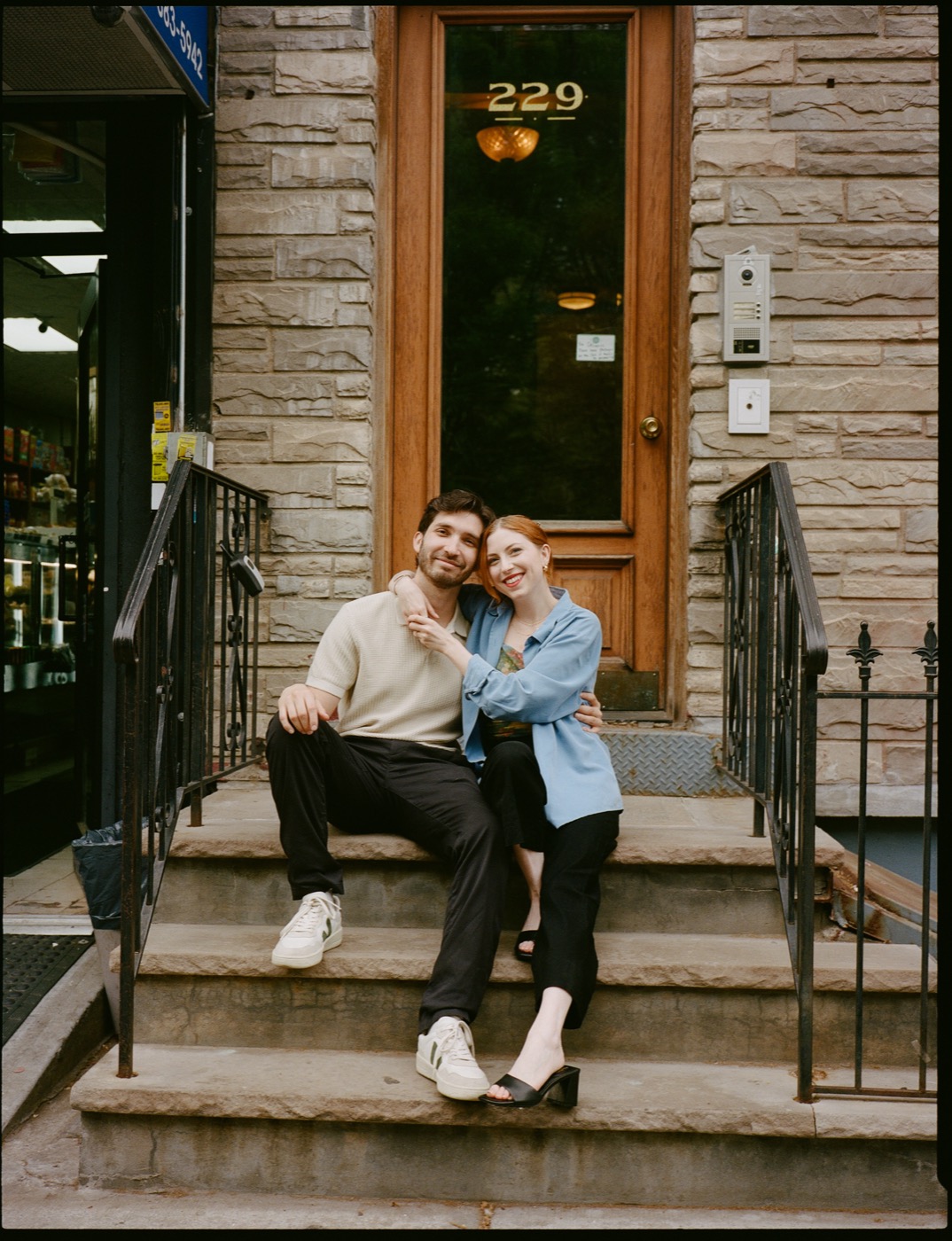 Emma and Gaston sitting together on a stoop
